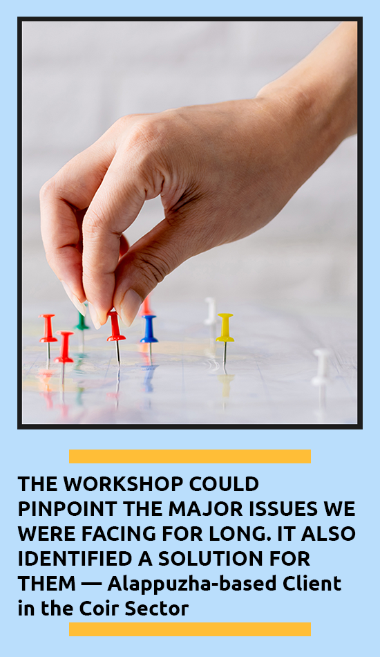 Hand shown placing thumbtacks on a whiteboard